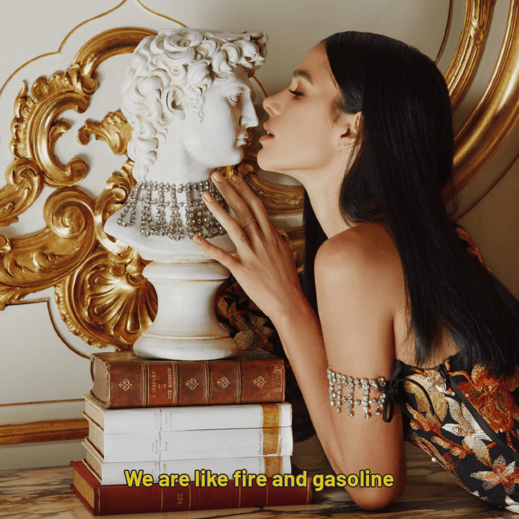 Bruna Marquezine beside a statue. Yellow caption: We are like fire and gasoline.