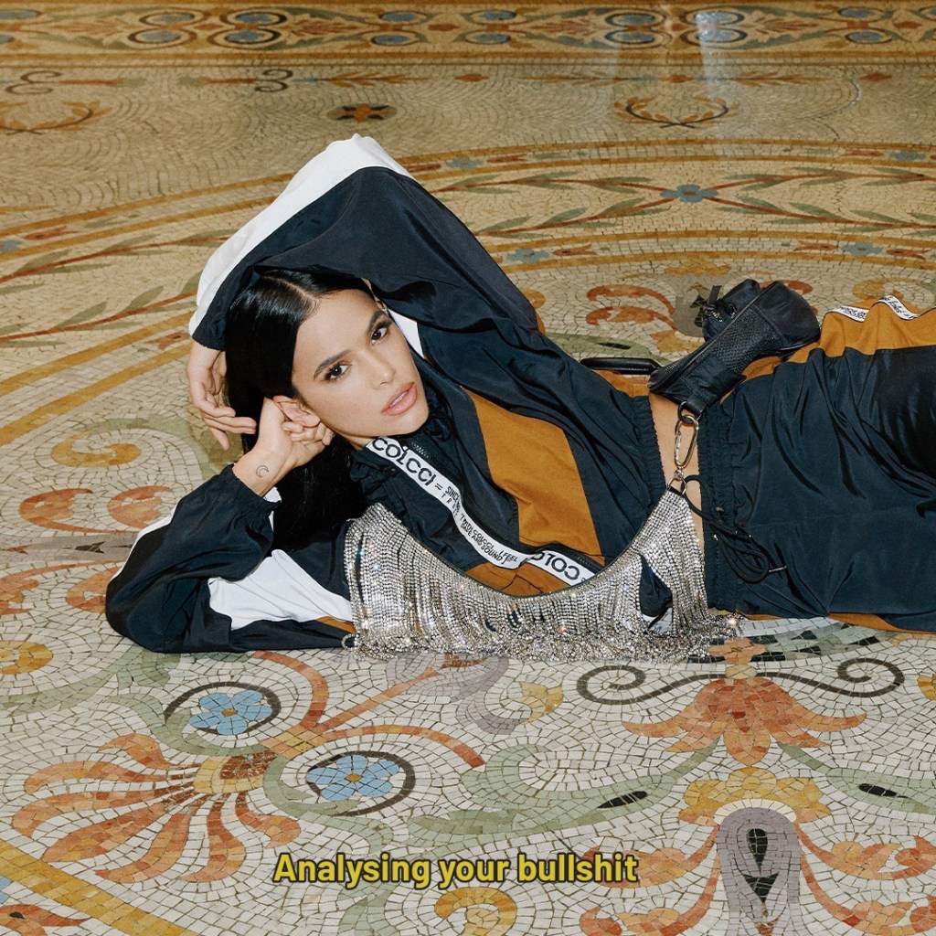 Bruna Marquezine lying on the floor. Yellow caption: Analysing your bullshit.